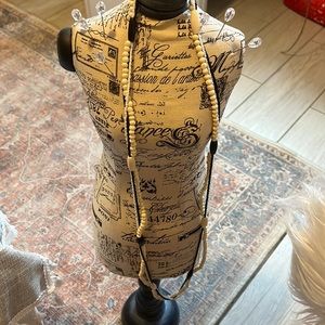 Long cream and black beaded necklace.